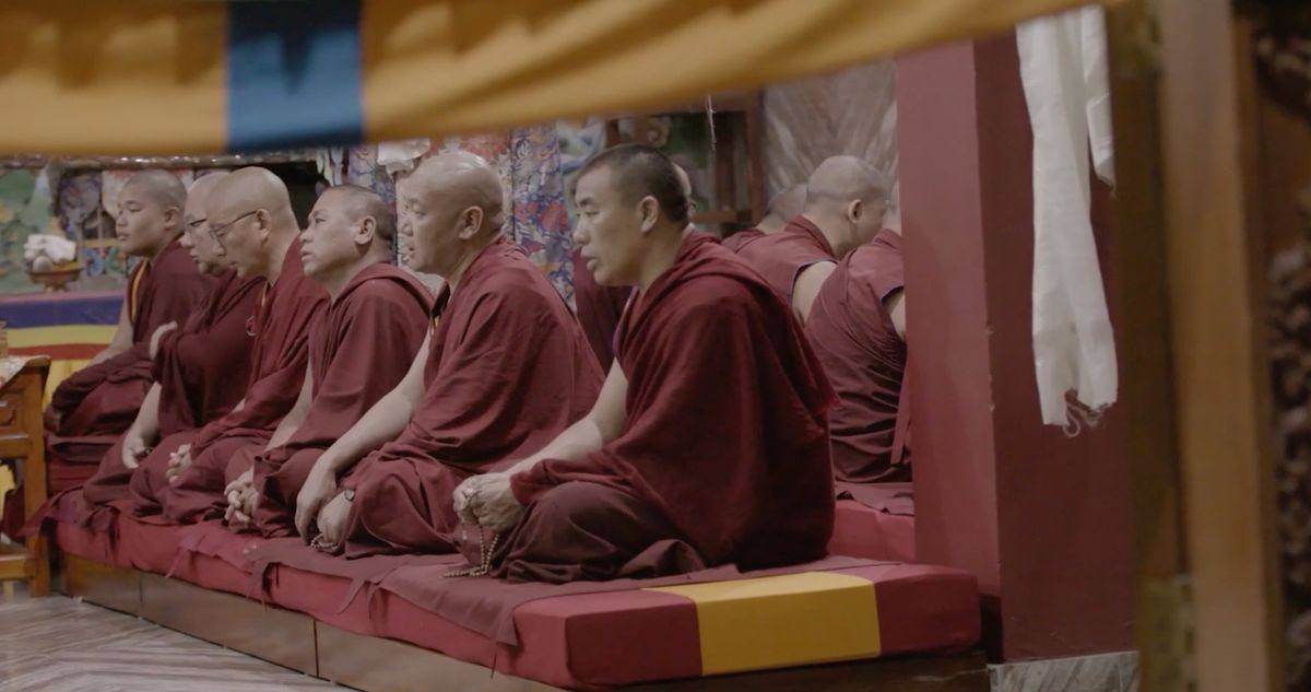 Monks chanting together in a temple