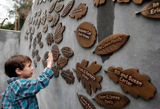 donor recognition wall with various names on leaf shaped plates